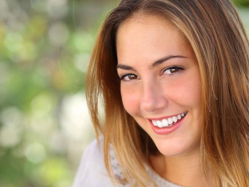 a woman smiling and showing her crowns